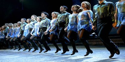 -riverdance-tor-lindstrand- men and women in a line dancing on stage