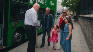 dodublin driver speaking to a family family of four standing on the path talking to a bus driver